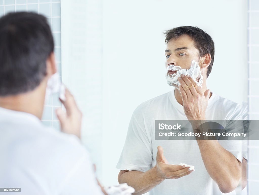 Morning Routine - Mature man shaving in front of  mirror Morning routine - Mature man shaving in front of a bathroom mirrorMore images like this: 40-44 Years Stock Photo