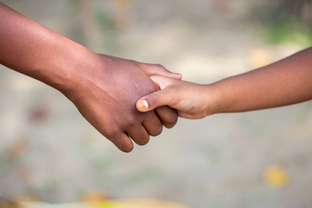istock A man shaking hands with another kid and blurred background 1824597359