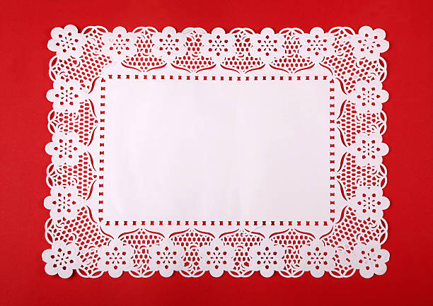 Rectangular doily on red cardboard Paper doily on red cardboard.See also doily stock pictures, royalty-free photos & images