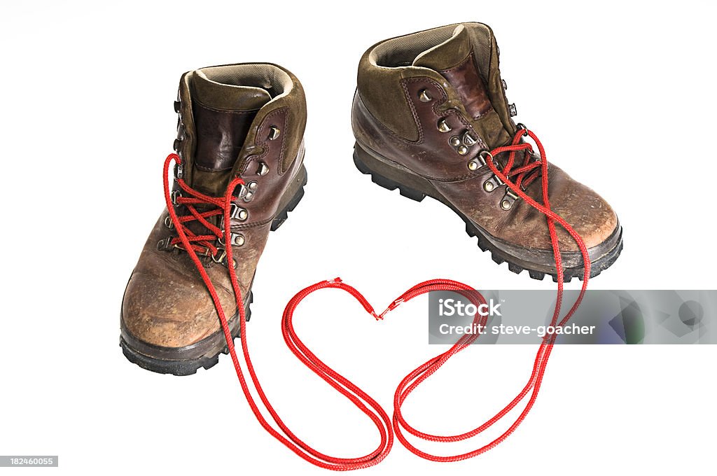 I love walking Pair of old brown leather walking boots isolated on white background with red laces arranged into heart shape. Heart Shape Stock Photo