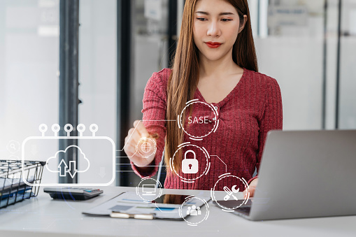 Hand touching Secure Access Service Edge icon on smartphone virtual screen background, password, network, framework and support technology in office. SASE secure access service edge concept.
