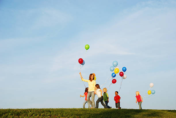 istock Kids Walking with Balloons 182460678