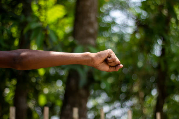istock A man has his hands clenched into fists and a light green background 1824607231