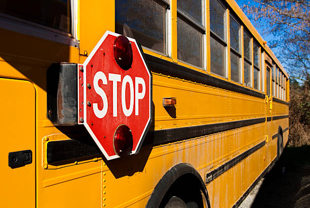 istock Stop sign on side of yellow school bus 182461174