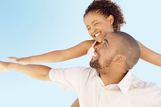 istock Girl enjoying a flight on her father's back 182461884