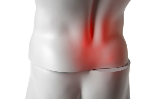 Close up of a mannequin back out of alignment with red indicating back pain.