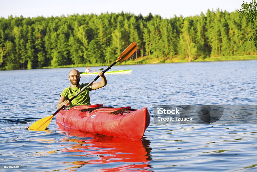 Young Man Kayaking "A young man kayaking, looking at camera." Kayaking Stock Photo