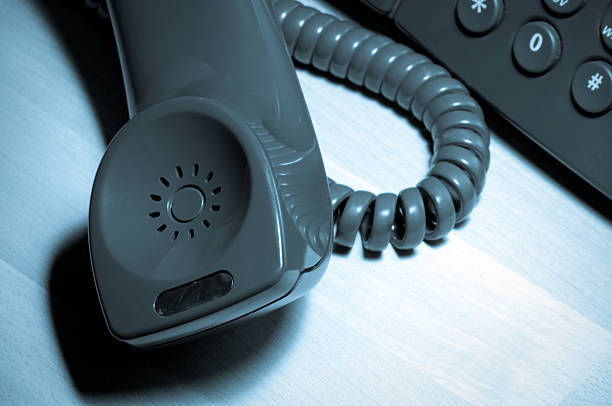 istock Working late at the office, on a call concept, toned 182462901