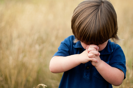 Little boy praying.