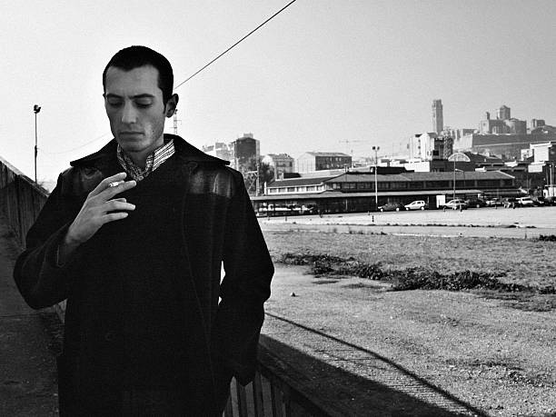 Young man smoking Young mod. Black and white with high contrast. Grain. My first portrait photosession some years ago. skin head stock pictures, royalty-free photos & images