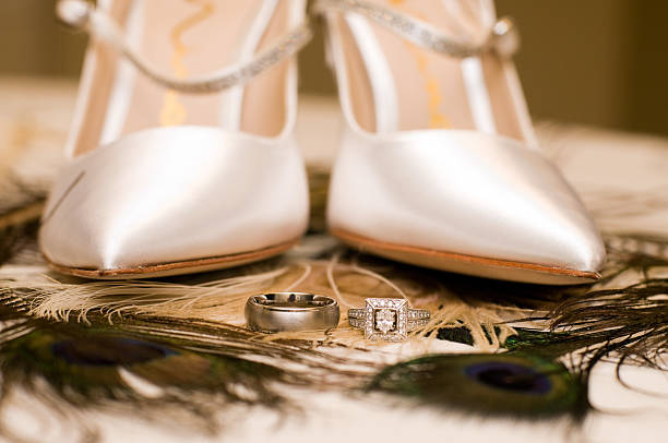 Bridal shoes and wedding rings stock photo