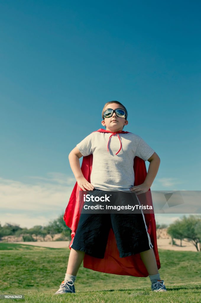 Captain Kid Confident superhero in a cape and goggles. Arms Akimbo Stock Photo