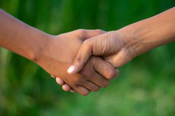 istock A man making handshake with another man and blur background 1824637299