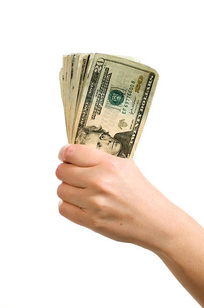 istock woman's hand holding money 182463920