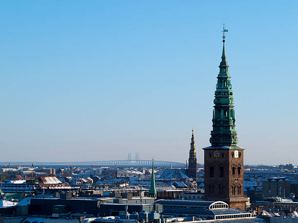 Church of Sct. Nikolaj in central Copenhagen in the foreeground and Church of Our Saivior at Christianshavn and the Oresund bridge are in the background.