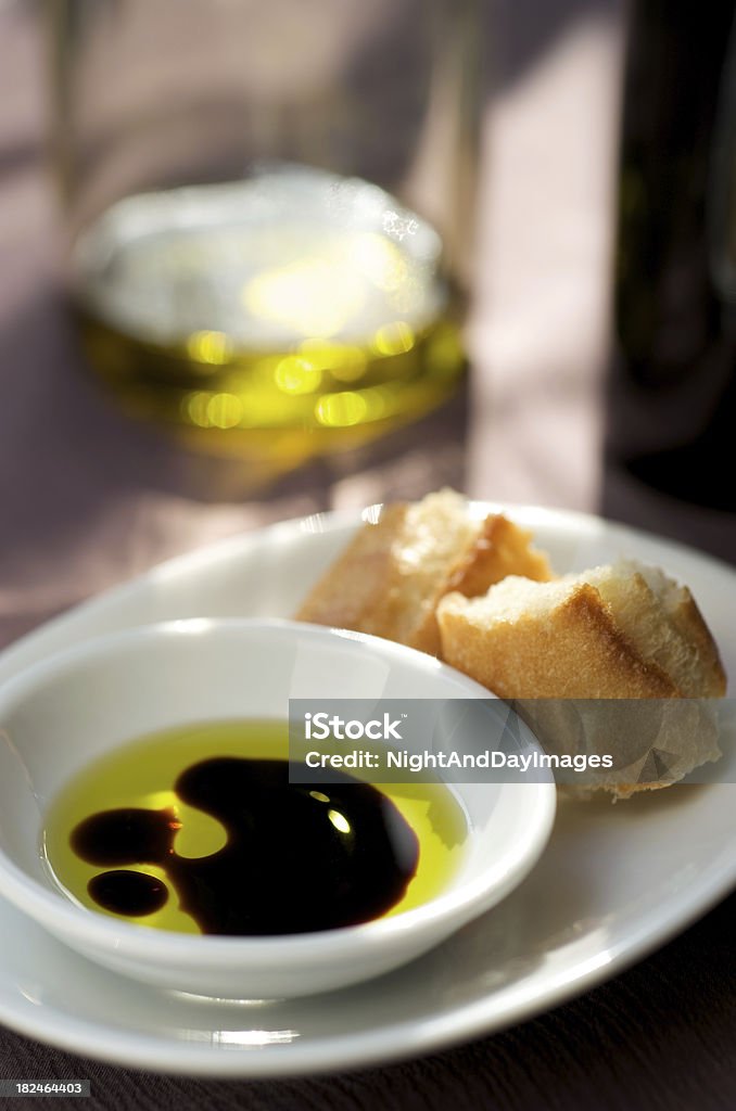 Balsamic Vinegar and Oil "An Italian appetizer of balsamic vinegar, olive oil and bread for dipping on a sunny afternoon." Vinegar Stock Photo