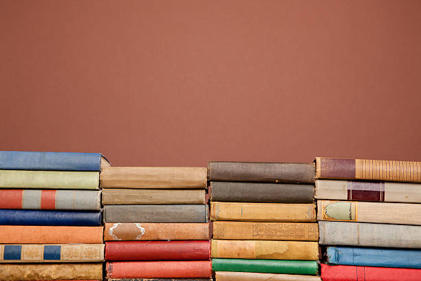 istock Ornate, Antique Books Lined in Front of Brown Background 182464481