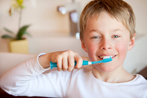 istock Child brushing his teeth happily in a bathroom 182464553