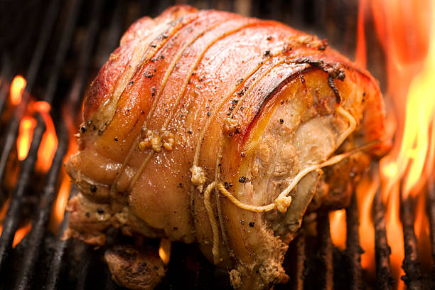 bonned and rolled pork roasting of a flame grill