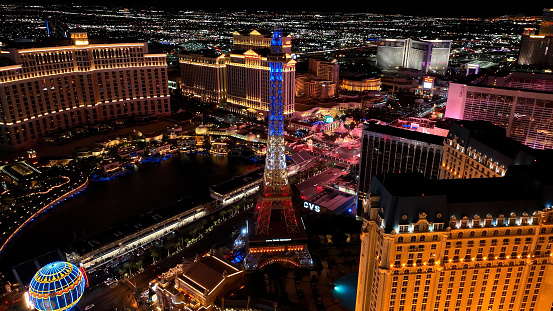 Las Vegas, Nevada/ USA - March 14, 2022: Aerial view of hotels on The Las Vegas Strip in city at night.\n\nLas Vegas is the largest city in the US state of Nevada and a world-renowned center for gambling, shopping, fine dining and entertainment. It is mainly famous for its many casinos and the accompanying entertainment-tourism activities, which earned it the nickname of the Entertainment Capital of the World.