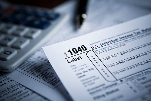 Financial IRS tax forms Income tax numbers at the accountants office 1040 tax form photos stock pictures, royalty-free photos & images