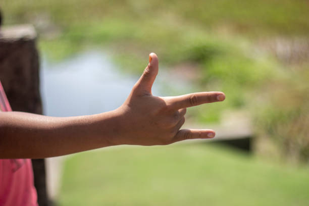 istock A man has his thumb pointing up and two finger forward and blurred background 1824653512