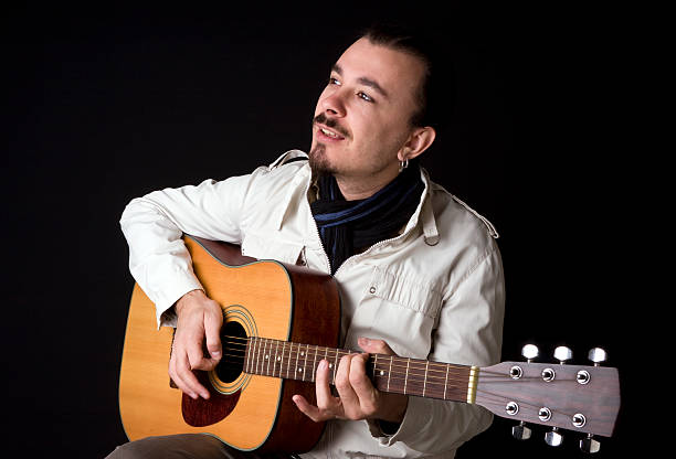istock Young musician playing guitar 182465592