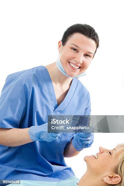 Female Dentist Or Dental Hygienist With Patient Stock Photo - Download Image Now - 30-34 Years, 50-54 Years, Adult