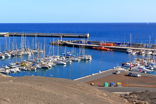November 24 2023 - Gran Tarajal, Fuerteventura, Canary Islands, Spain in Europe: a Search And Rescue Vessel Moored in Harbour between private ships