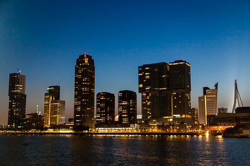 Bay of the night city of Rotterdam in the Netherlands with high-rise buildings.