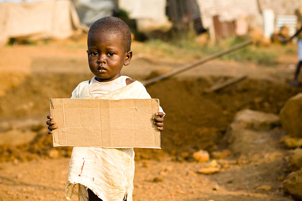 istock African Boy holding a blank cardboard sign 182466540