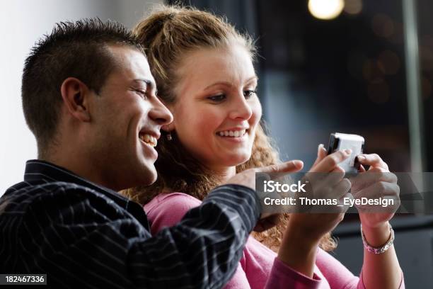 Couple Laughing At Cell Phone Stock Photo - Download Image Now - 20-29 Years, Adult, Adults Only