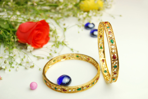 Beautiful Gold Bangles - Red Rose in background with decorative marble stones