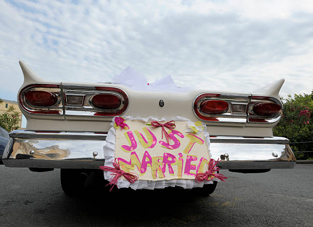 istock White convertible car with Just Married sign on the back 182467875