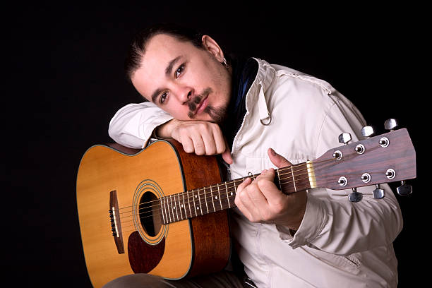 istock Young musician playing guitar 182468072