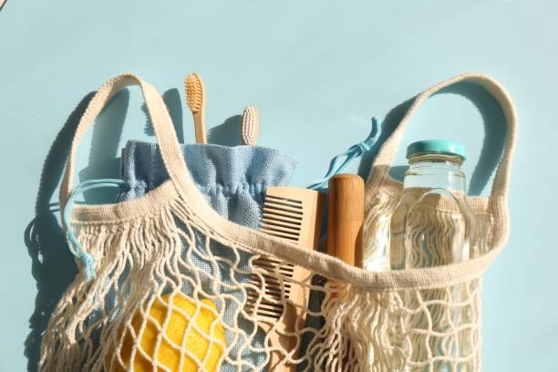 istock Fishnet bag with different items on light blue background, top view. Conscious consumption 1824683446