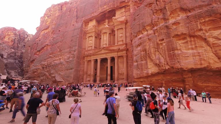 Close up zoom out view tourist by visit The temple-mausoleum of Al Khazneh in the ancient city of Petra in Jordan