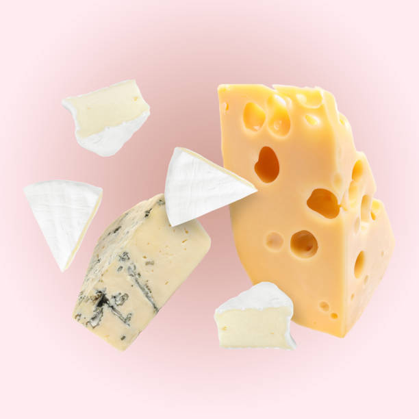 istock Different kinds of cheese falling on light pink background 1824685282