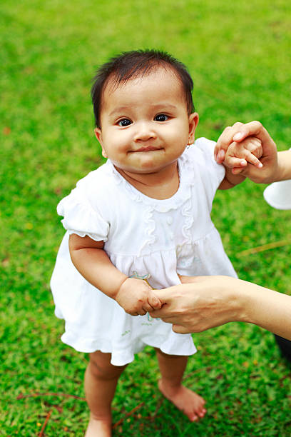 istock lovely baby holding parent's hand 182468794