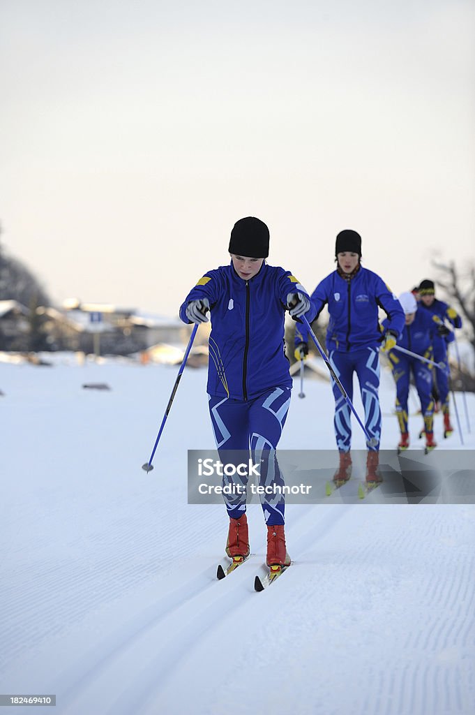 Cross country skiers in the line Front view of four  young cross country skiers practicing classic style Cross-Country Skiing Stock Photo