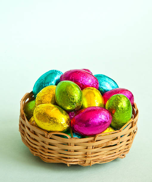 Basket of brightly coloured foil-wrapped mini Easter Eggs stock photo
