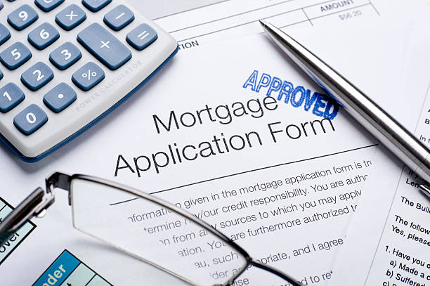 istock Approved Mortgage application form with a calculator and pen 182470004