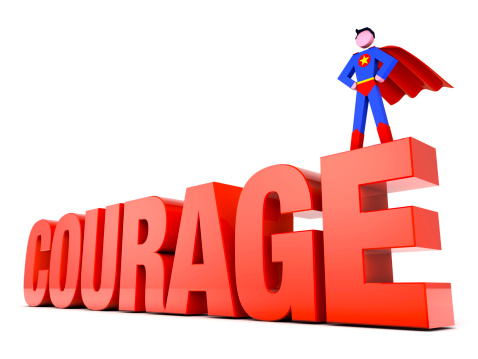 Superhero stood atop word - Courage