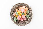 Turkish delight on authentic plate isolated on white background