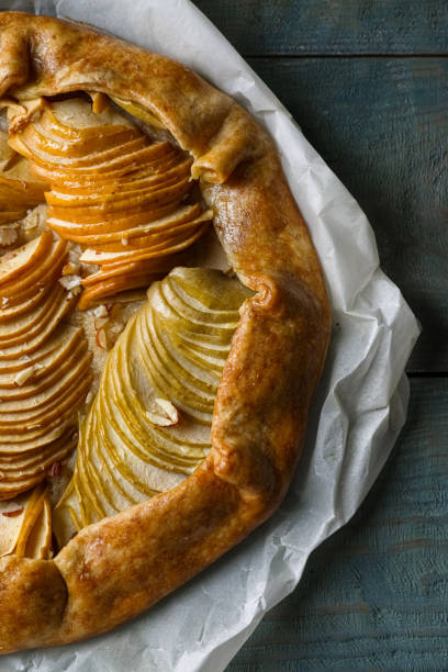 istock Delicious apple galette with walnuts on wooden table, top view 1824703400