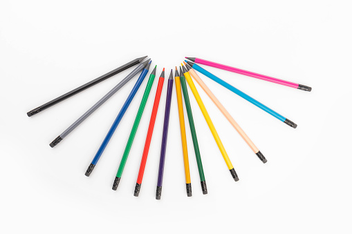 Colorful pencils. Wooden color pencils arranged in row on white isolated background. Selective focus