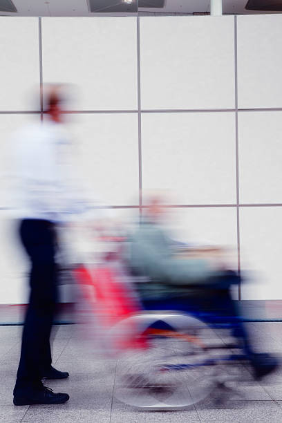 istock Man Pushing his Father Sitting in Wheelchair, Blurred Motion 182470766