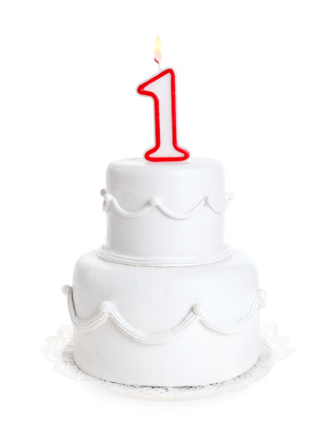 White birthday cake with number candle.