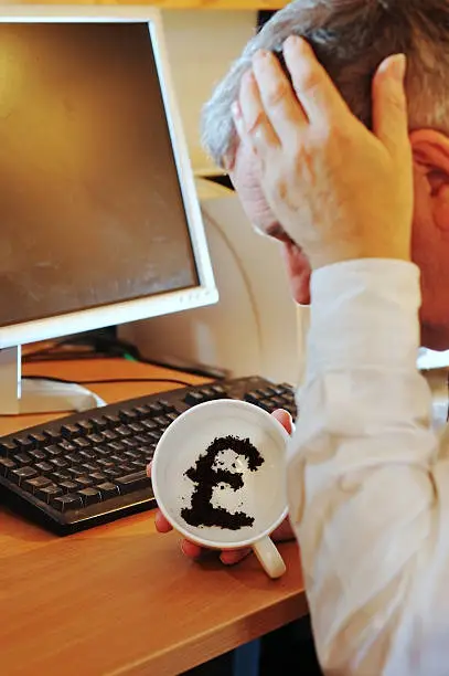 "Businessman/financier showing pound symbol in tea-leaves, unhappy with the future of the pound.For different currencies and expressions, please see this LB"