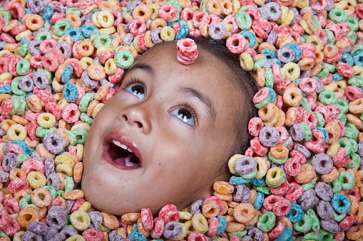 little girl buried in cereal